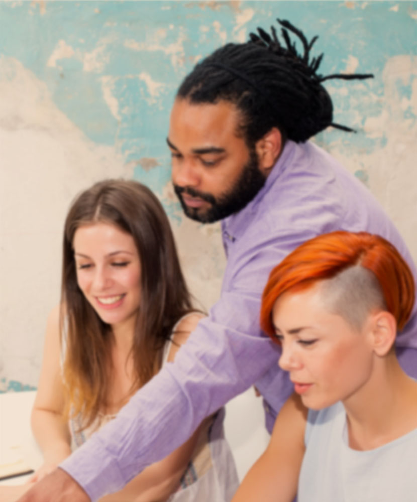 Diverse team collaborating on a project, empowered through digital innovation and cultural hacking.