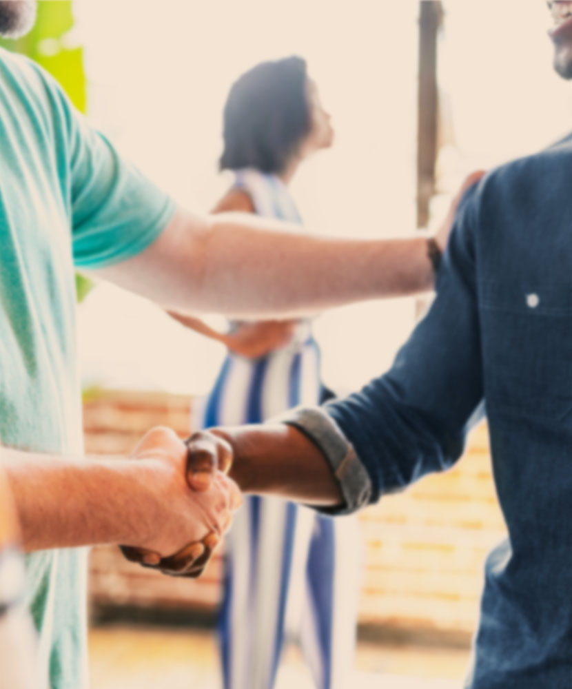Team members shaking hands, symbolizing collaboration and strong employee engagement