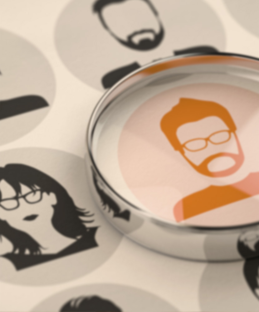 Magnifying glass highlighting a candidate, symbolizing talent acquisition and building teams with excellence