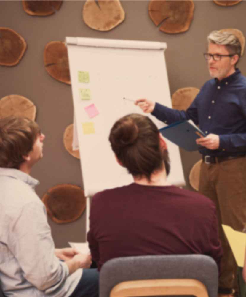 Team building and development session with a facilitator guiding a group, enhancing collaboration and performance