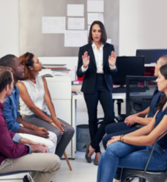 Coaching session with a professional coach guiding a team through a discussion, enhancing leadership and collaboration