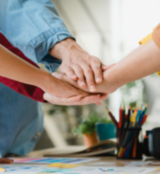 Team members shaking hands, symbolizing collaboration and strong employee engagement