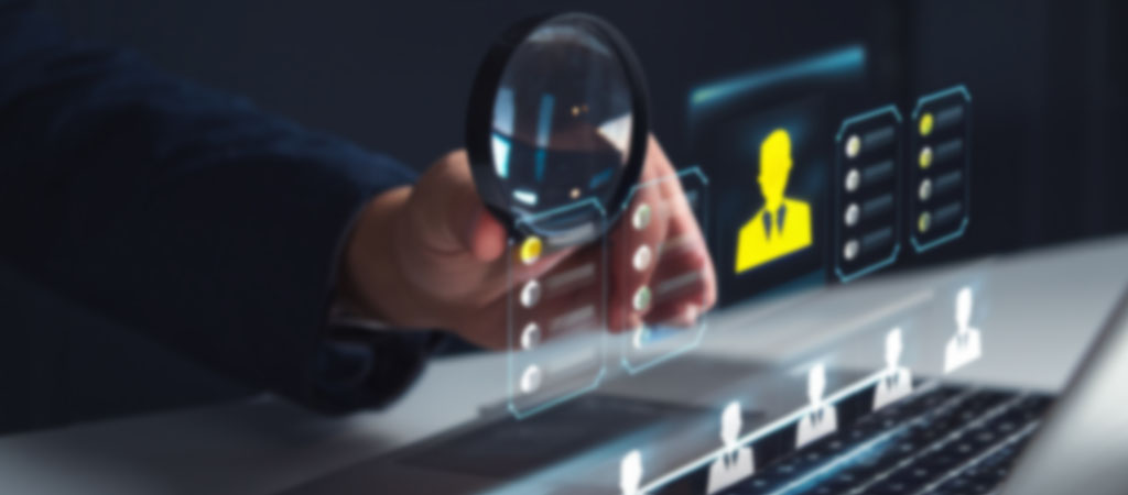 Magnifying glass highlighting a candidate, symbolizing talent acquisition and building teams with excellence